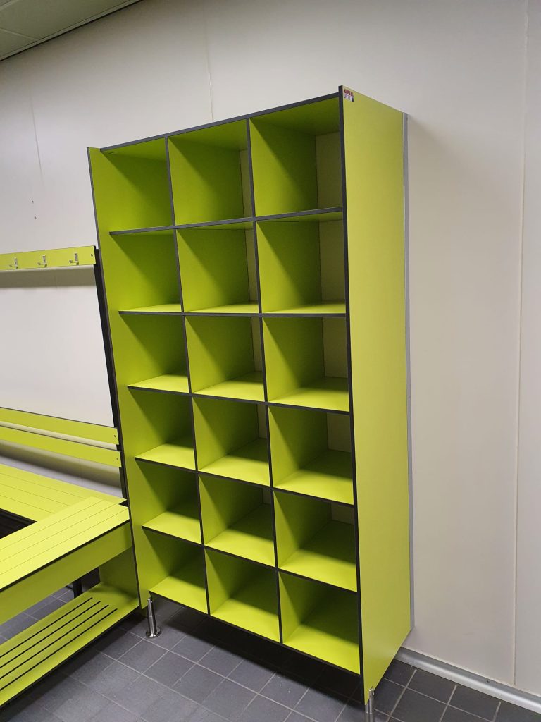 Open limoengroene vakkenkast naast een zitbank